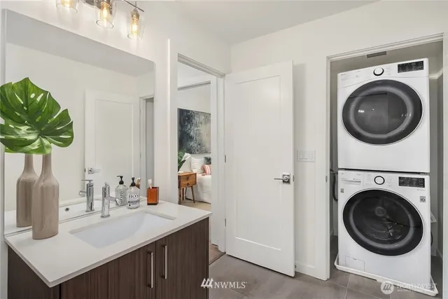 a bathroom with a sink a washer and dryer