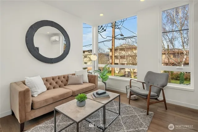 a living room with furniture a rug and a painting