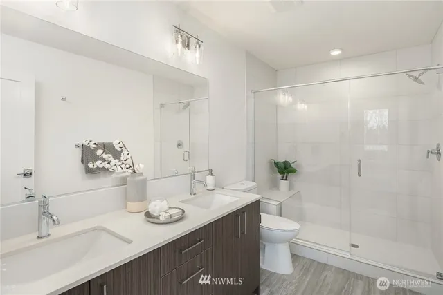 a bathroom with a granite countertop sink toilet and shower