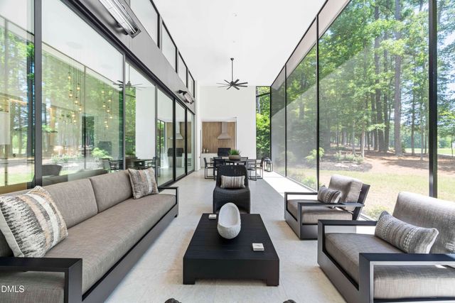 a living room with furniture and a floor to ceiling window