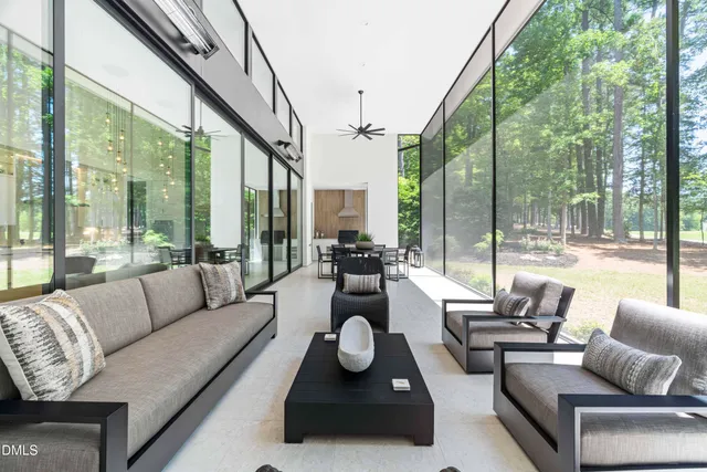 a living room with furniture and a floor to ceiling window
