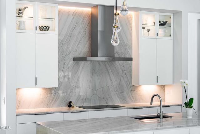 a kitchen with stainless steel appliances granite countertop a sink and refrigerator