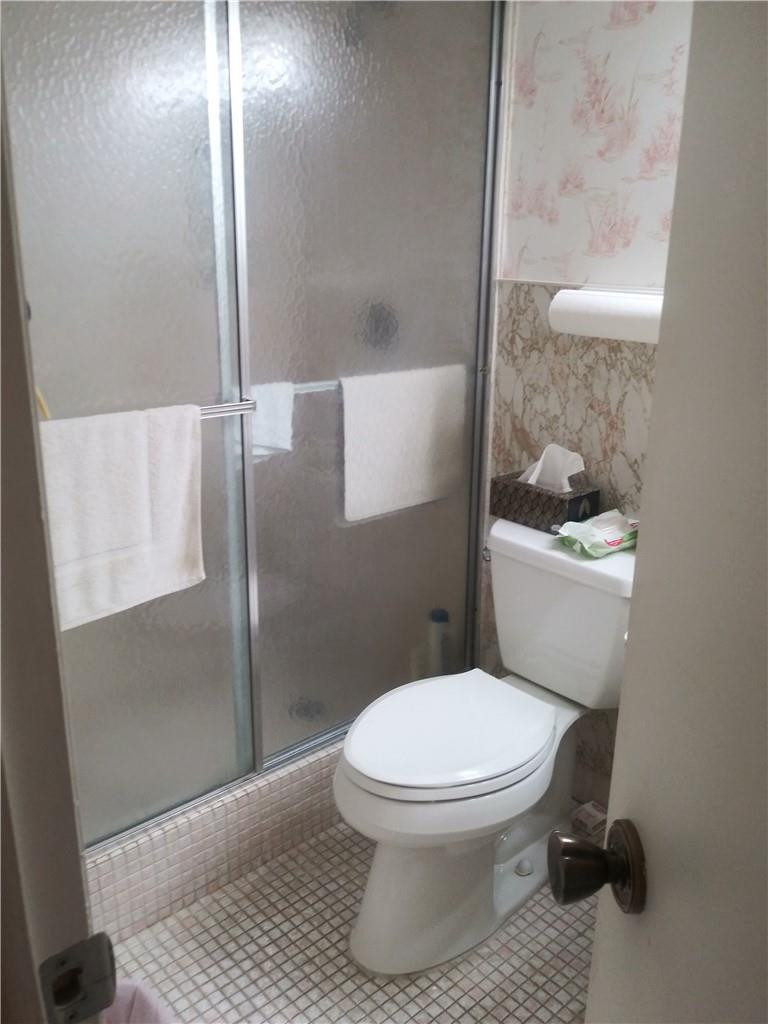 601 South State Road 7, Unit 1C Margate, FL 33068 - Photo 4 of 7 a white toilet sitting next to a bathroom sink
