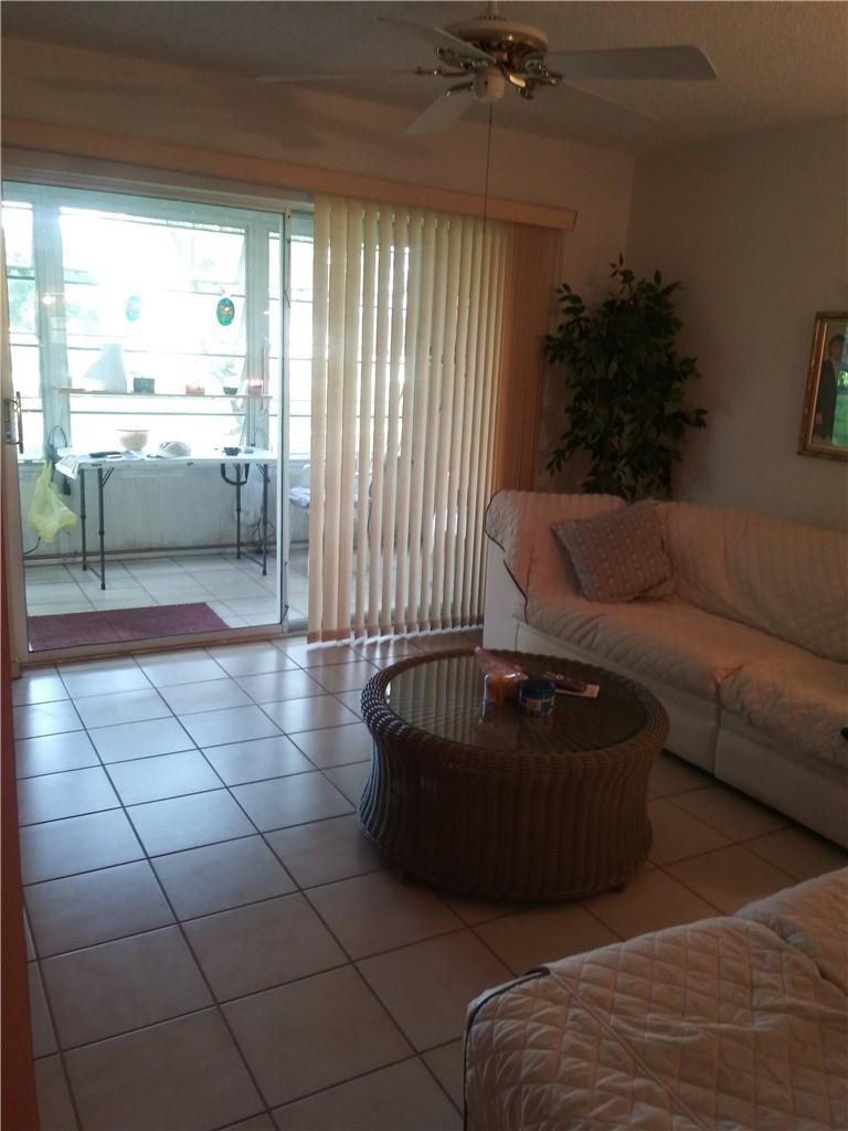 601 South State Road 7, Unit 1C Margate, FL 33068 - Photo 5 of 7 a living room with couches and a coffee table