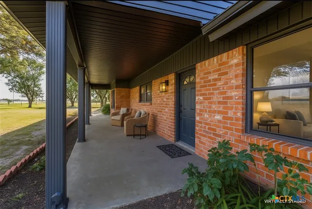 a couple of chairs and a fireplace in a balcony