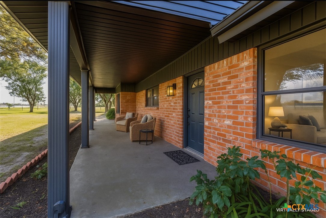 a couple of chairs and a fireplace in a balcony