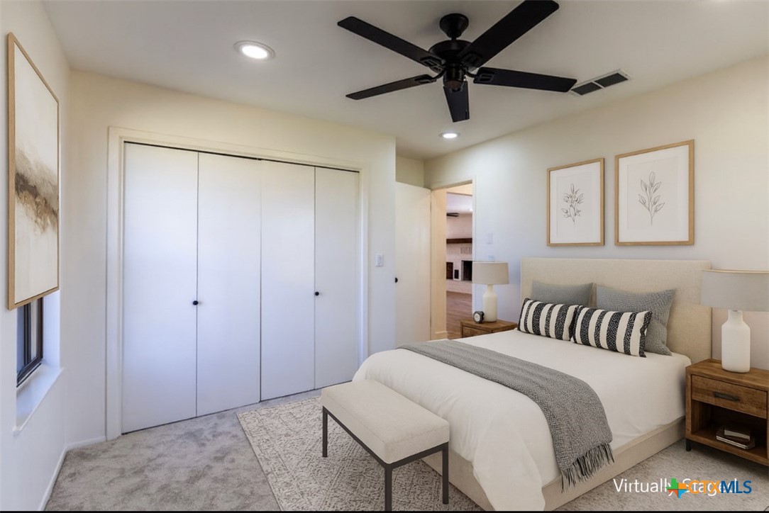 286 South Baese Road Elm Mott, TX 76640 - Photo 16 of 23 a spacious bedroom with a bed and a chandelier