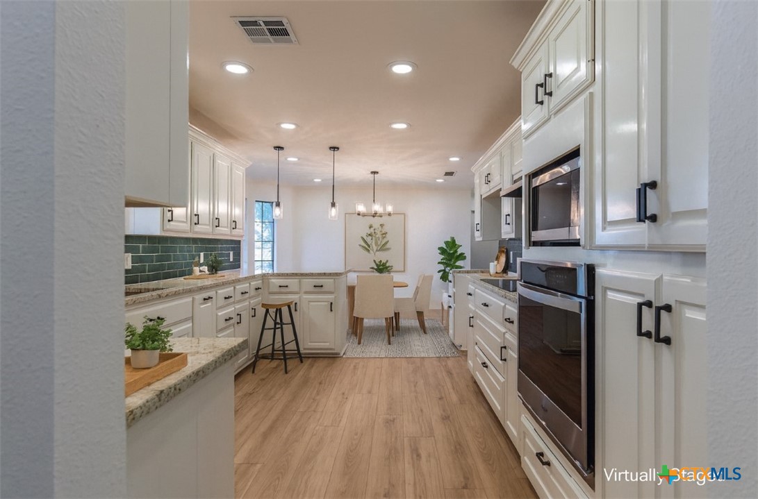 286 South Baese Road Elm Mott, TX 76640 - Photo 6 of 23 a large kitchen with stainless steel appliances lots of counter space and a wooden floors