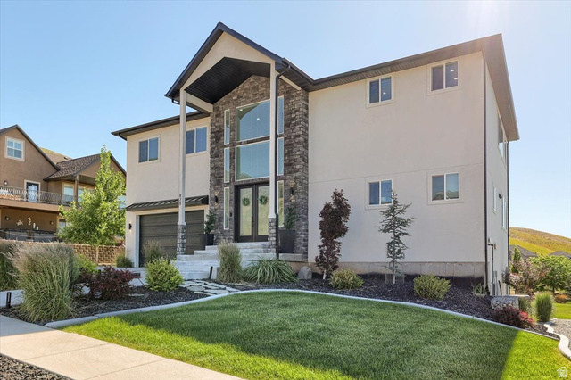Contemporary two-story residence featuring a stone and stucco facade