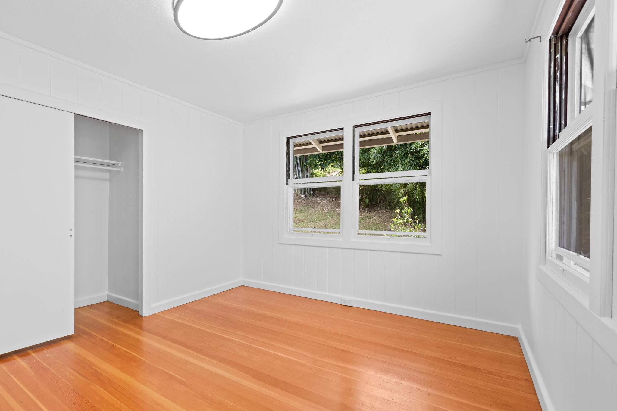 53 Ekaha Street Hilo, HI 96720 - Photo 6 of 29 a view of an empty room with wooden floor and a window