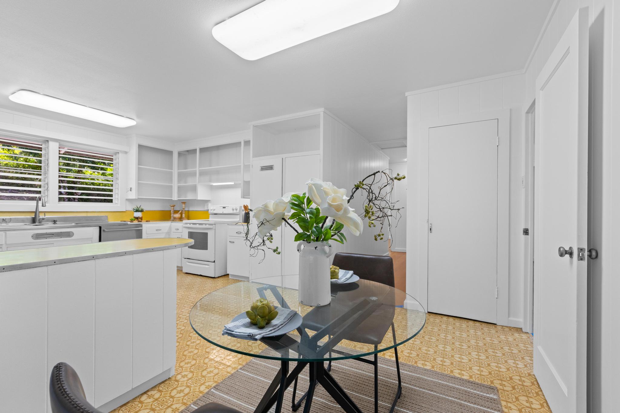 53 Ekaha Street Hilo, HI 96720 - Photo 7 of 29 a dining room with furniture potted plants and wooden floor