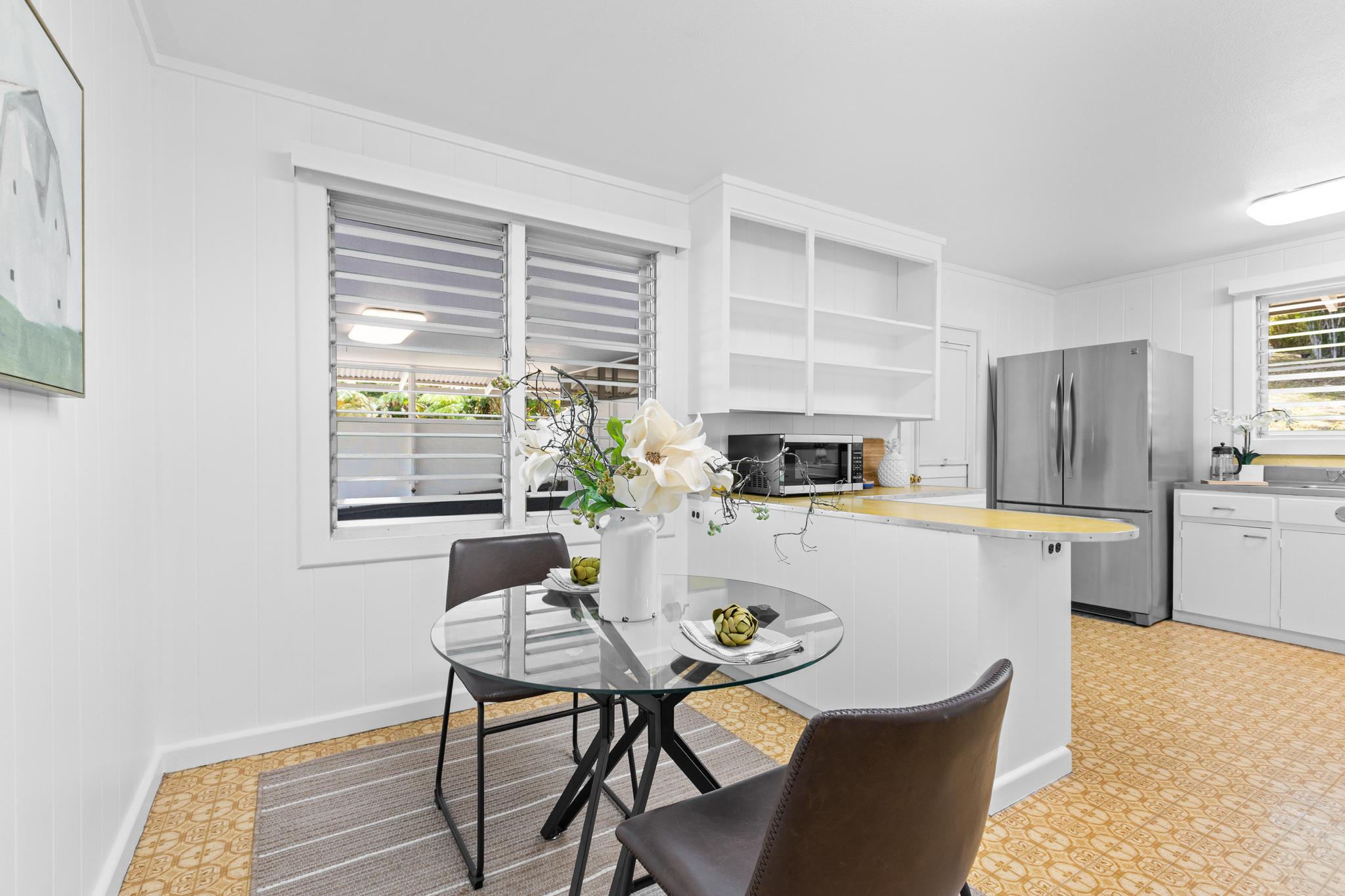 53 Ekaha Street Hilo, HI 96720 - Photo 8 of 29 a kitchen with a table chairs and a refrigerator