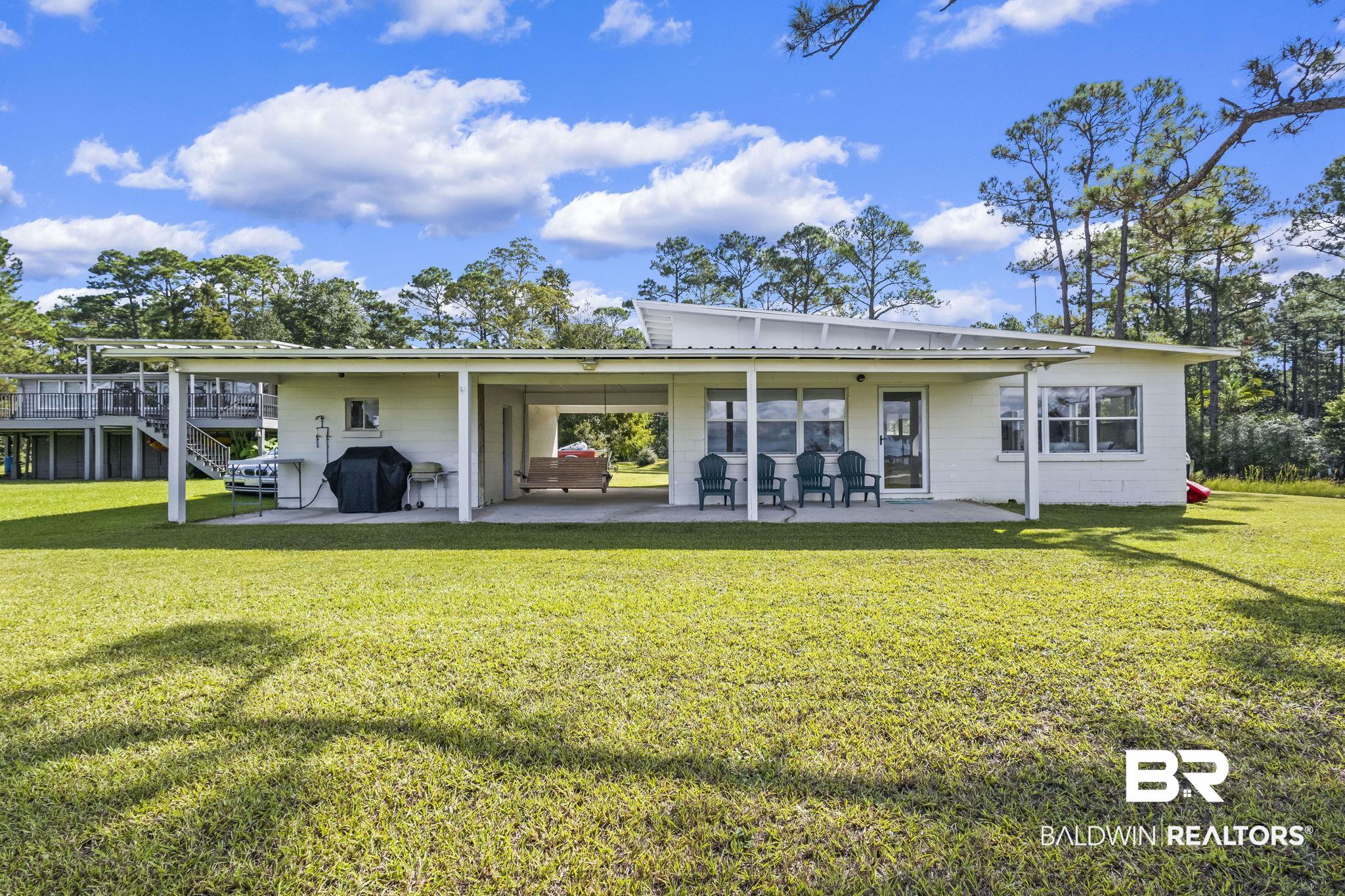7849 Bayshore Drive Elberta, AL 36530 - Photo 41 of 47 Rear view of house with a yard and a patio area