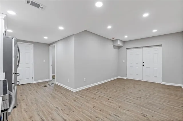 a view of an empty room with wooden floor