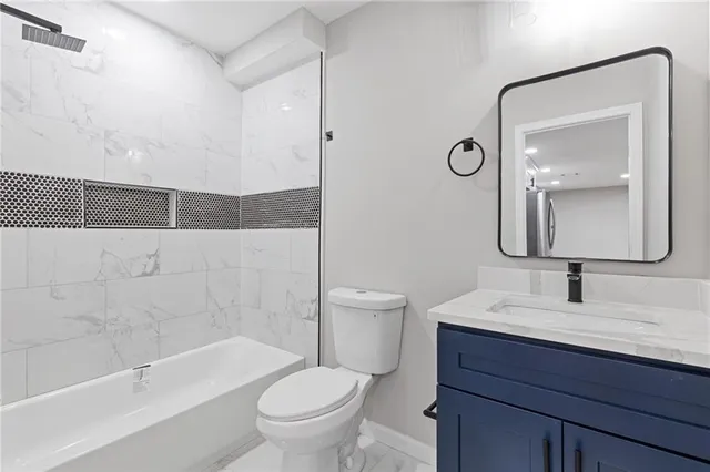 a bathroom with a toilet a sink a bathtub and a mirror