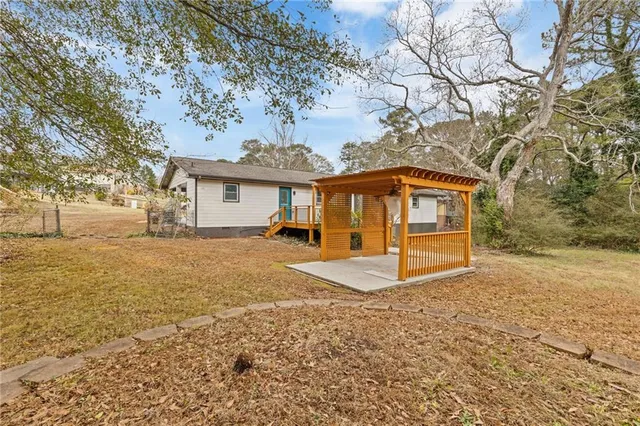 a view of a white house with a yard
