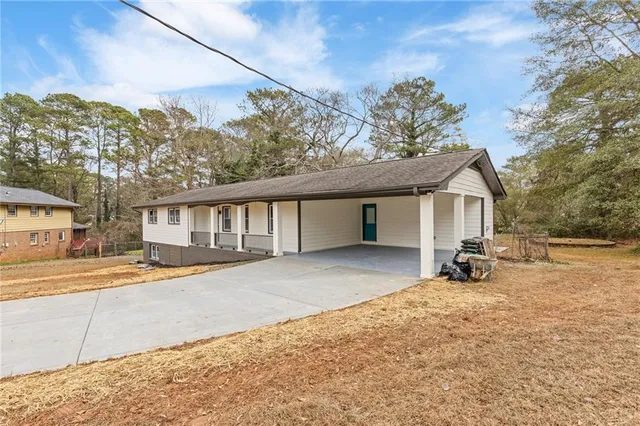 a backyard of a house with barbeque oven and outdoor seating