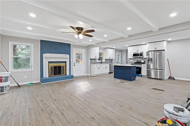a view of kitchen with furniture and a fireplace