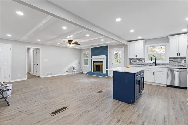 a kitchen with a sink cabinets and wooden floor