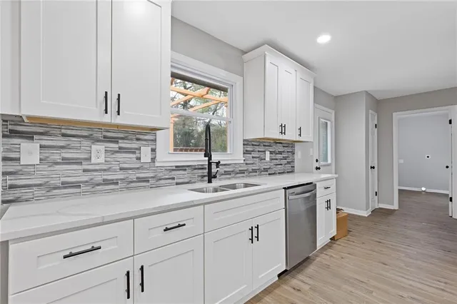 a kitchen with a sink stove and cabinets