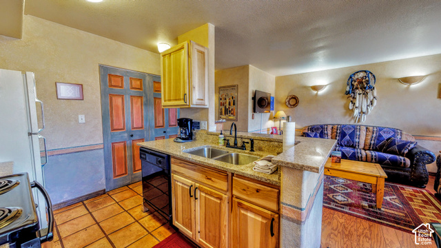 3299 Fairway Loop Moab, UT 84532 - Photo 5 of 23 Kitchen with wood-finish cabinetry, granite-style countertops, and a double basin stainless steel sink