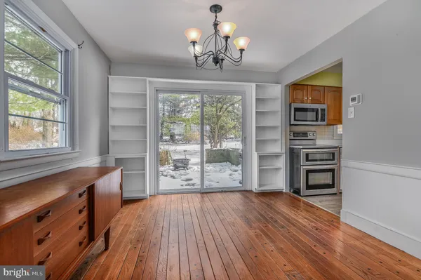 a view of a room with a window and wooden floor