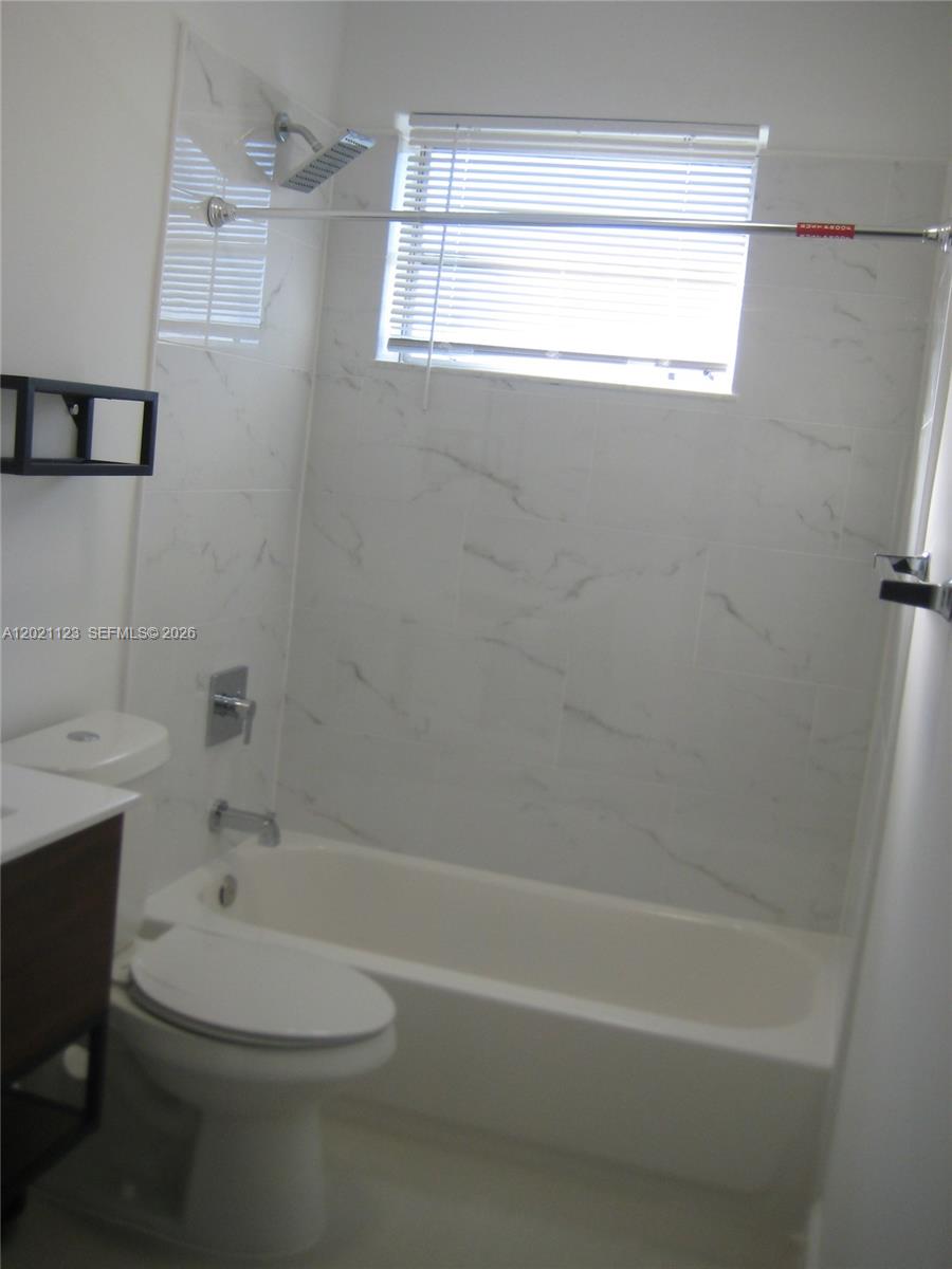 13220 Southwest 99th Place Miami, FL 33176 - Photo 11 of 16 a bathroom with a toilet a sink and a bathtub