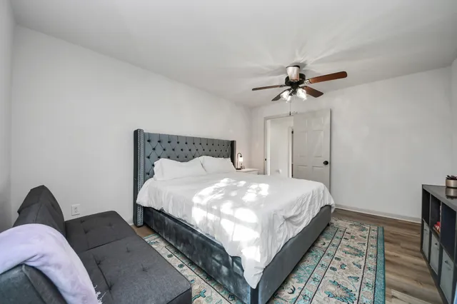 a bedroom with a bed and a chandelier