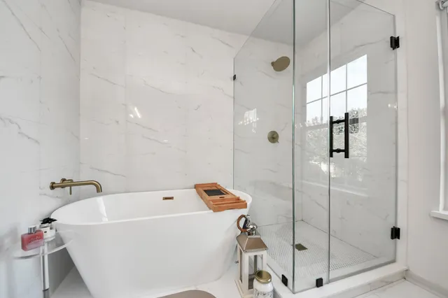a bathroom with a bathtub and shower