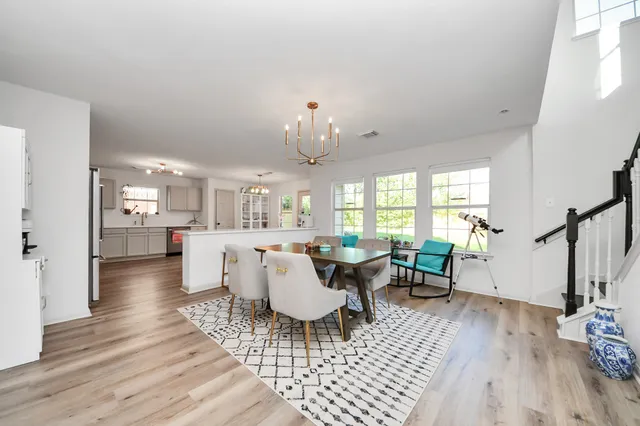 a living room with furniture a window and wooden floor