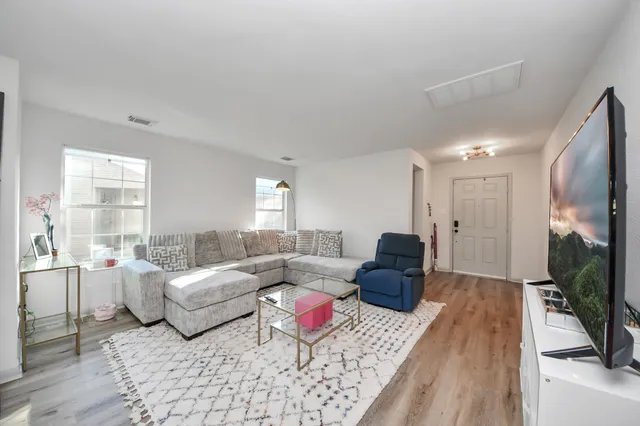 a living room with furniture fireplace and a flat screen tv