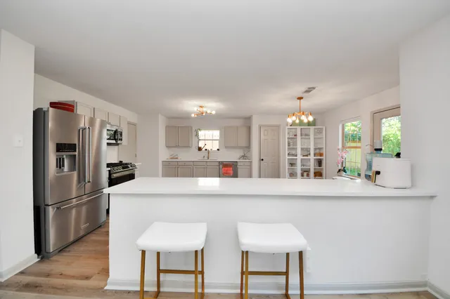 a kitchen with stainless steel appliances a sink and a refrigerator