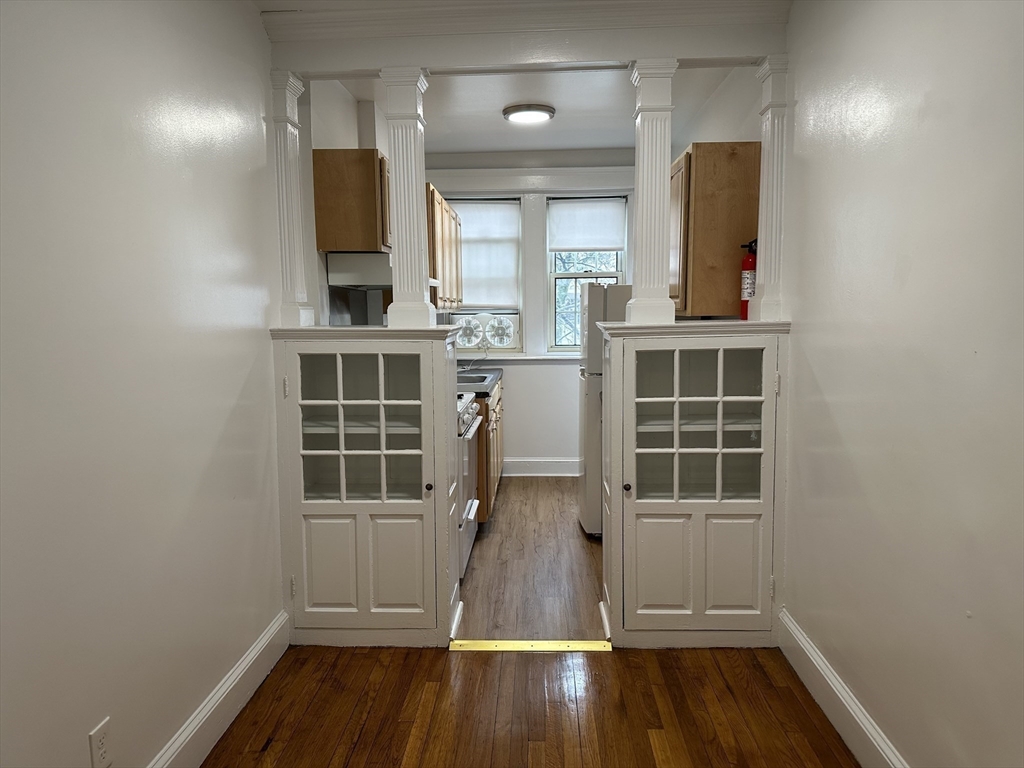 1 Craigie Street, Unit 26 Cambridge, MA 02138 - Photo 11 of 20 an empty room with wooden floor and windows