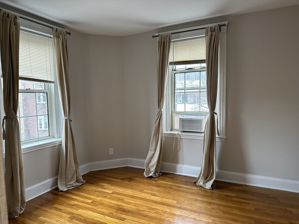 1 Craigie Street, Unit 26 Cambridge, MA 02138 - Photo 16 of 20 a view of an empty room with wooden floor and a window