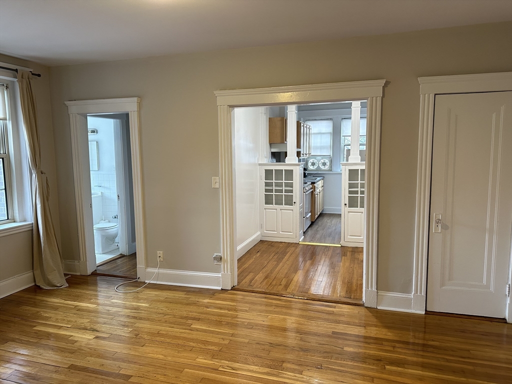 1 Craigie Street, Unit 26 Cambridge, MA 02138 - Photo 2 of 20 a view of empty room with wooden floor and fan