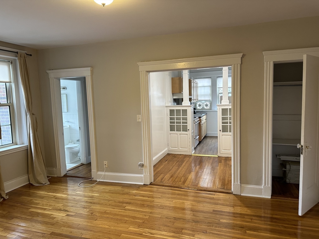 1 Craigie Street, Unit 26 Cambridge, MA 02138 - Photo 3 of 20 an empty room with wooden floor and windows