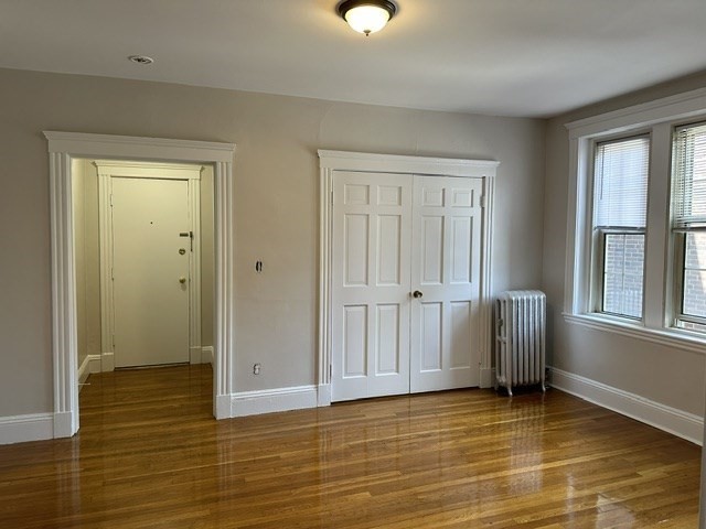 1 Craigie Street, Unit 26 Cambridge, MA 02138 - Photo 4 of 20 a view of an empty room with window and wooden floor