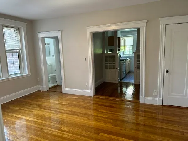 an empty room with wooden floor and closet
