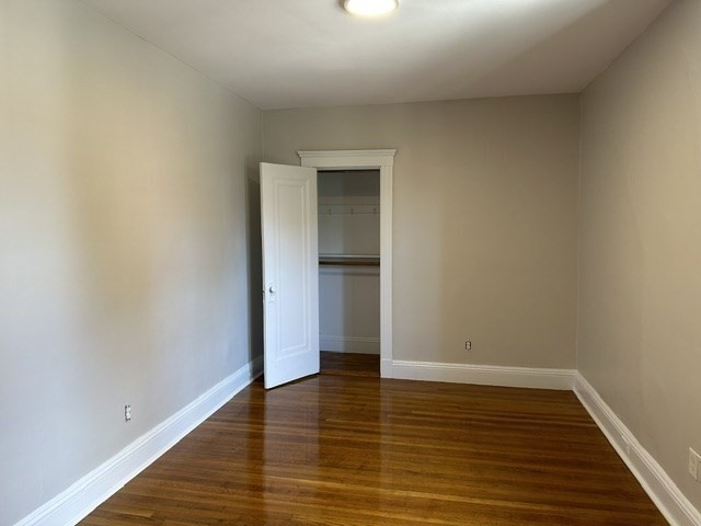 1 Craigie Street, Unit 26 Cambridge, MA 02138 - Photo 8 of 20 a view of an empty room with wooden floor and a window