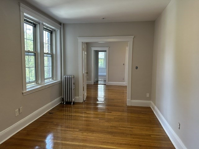 1 Craigie Street, Unit 26 Cambridge, MA 02138 - Photo 9 of 20 a view of an empty room with window and wooden floor