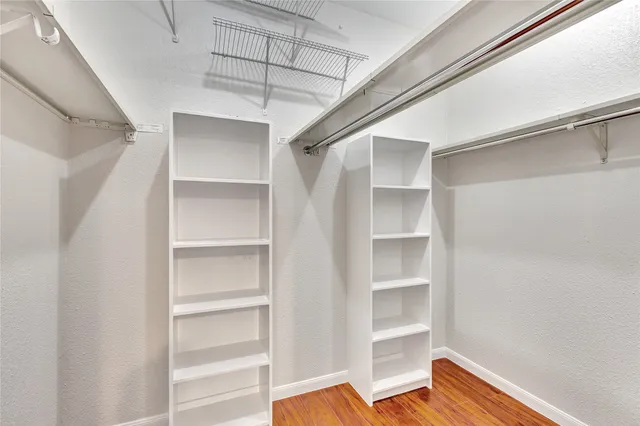 a view of walk in closet with empty racks