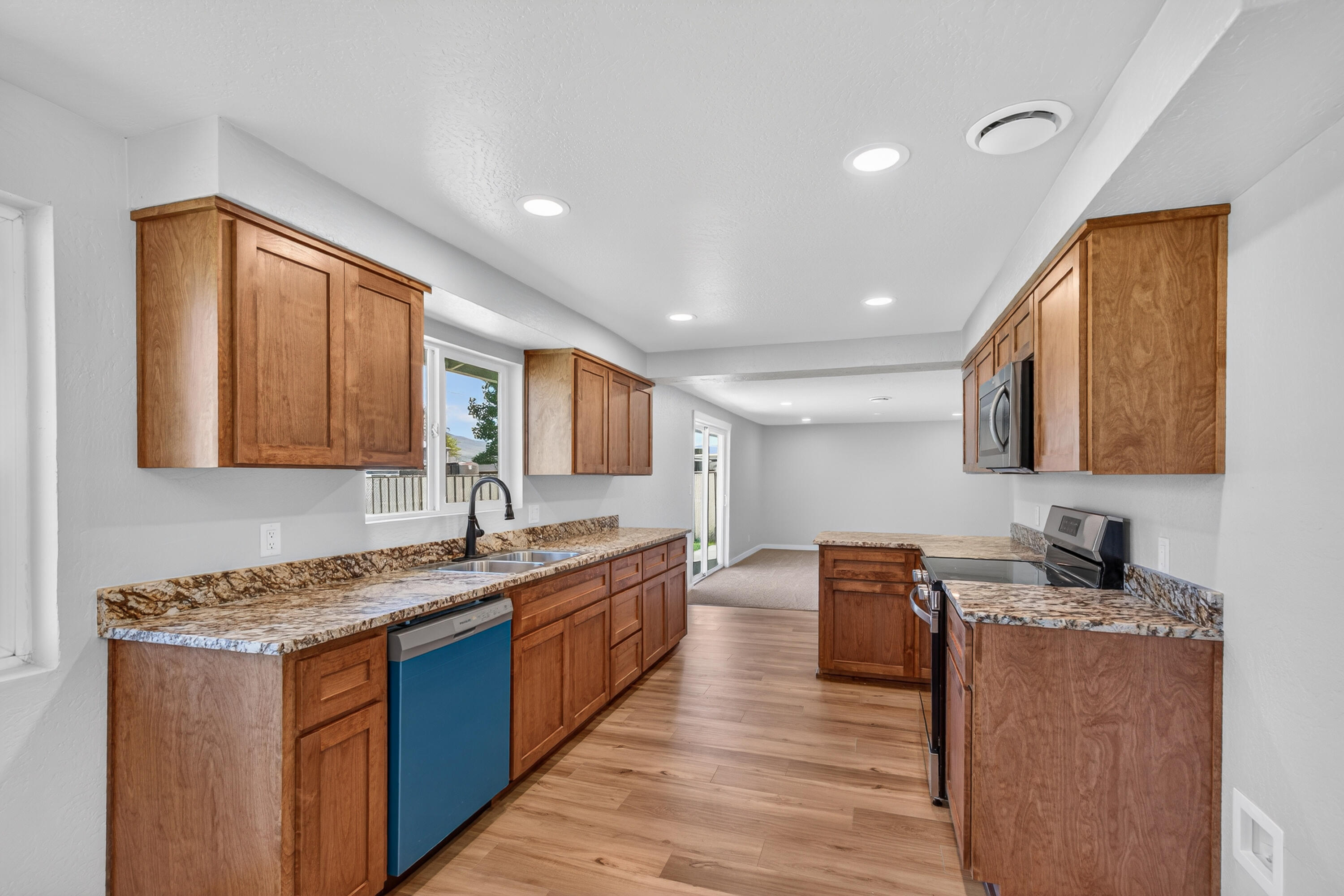 550 Experiment Station Road Medford, OR 97501 - Photo 10 of 27 a kitchen with stainless steel appliances granite countertop wooden cabinets a sink and dishwasher