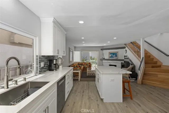 a kitchen with sink a stove and cabinets