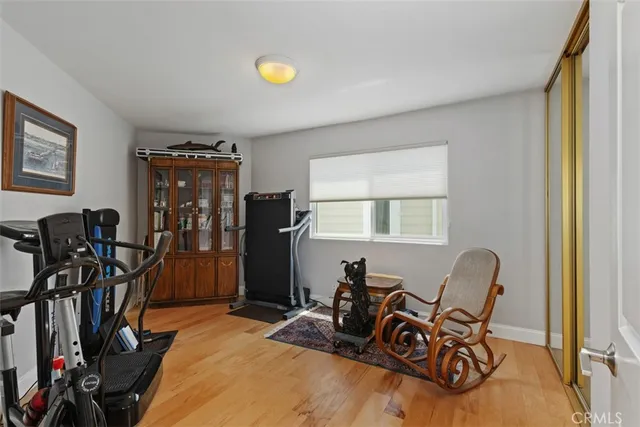 a living room with furniture a flat screen tv and a window