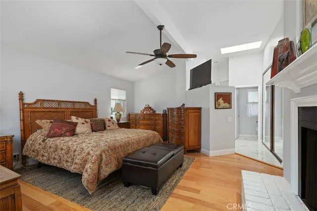 a bedroom with a bed couch and a ceiling fan