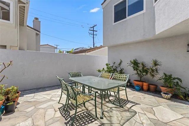 a patio with a table and chairs