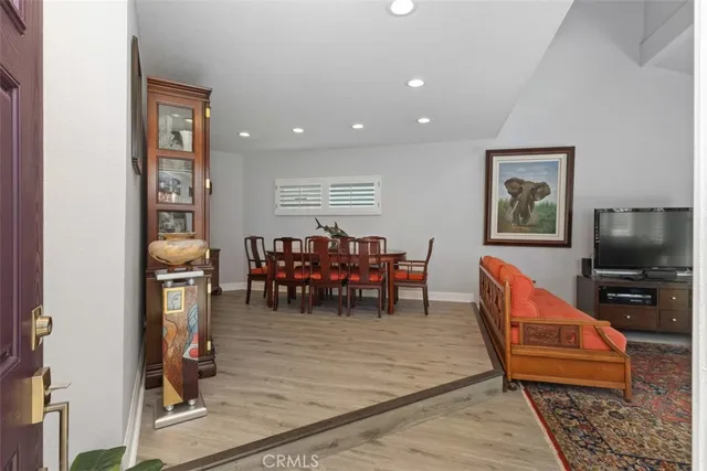 a living room with furniture a dining table and kitchen view