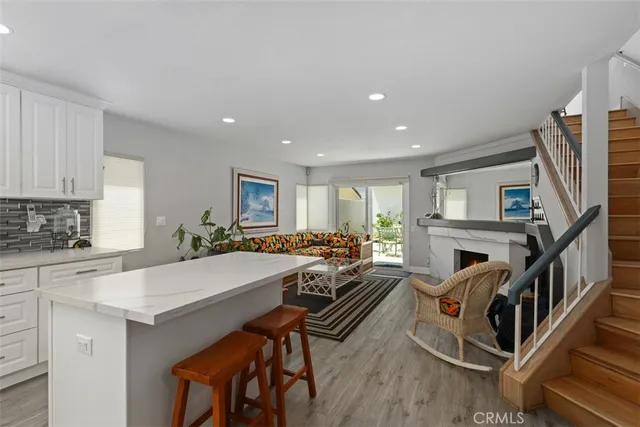 a room with furniture a fireplace and a kitchen view