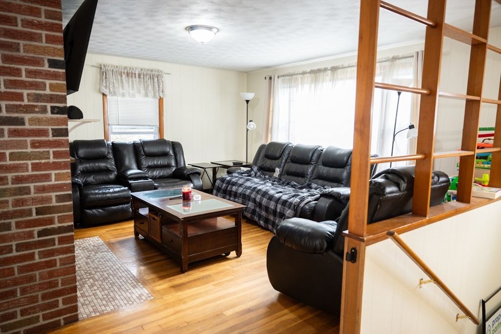 10 Chris Road Oxford, MA 01540 - Photo 11 of 42 a living room with furniture and a flat screen tv