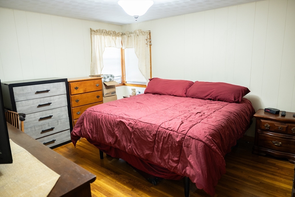 10 Chris Road Oxford, MA 01540 - Photo 18 of 42 a bedroom with a bed and wooden floor